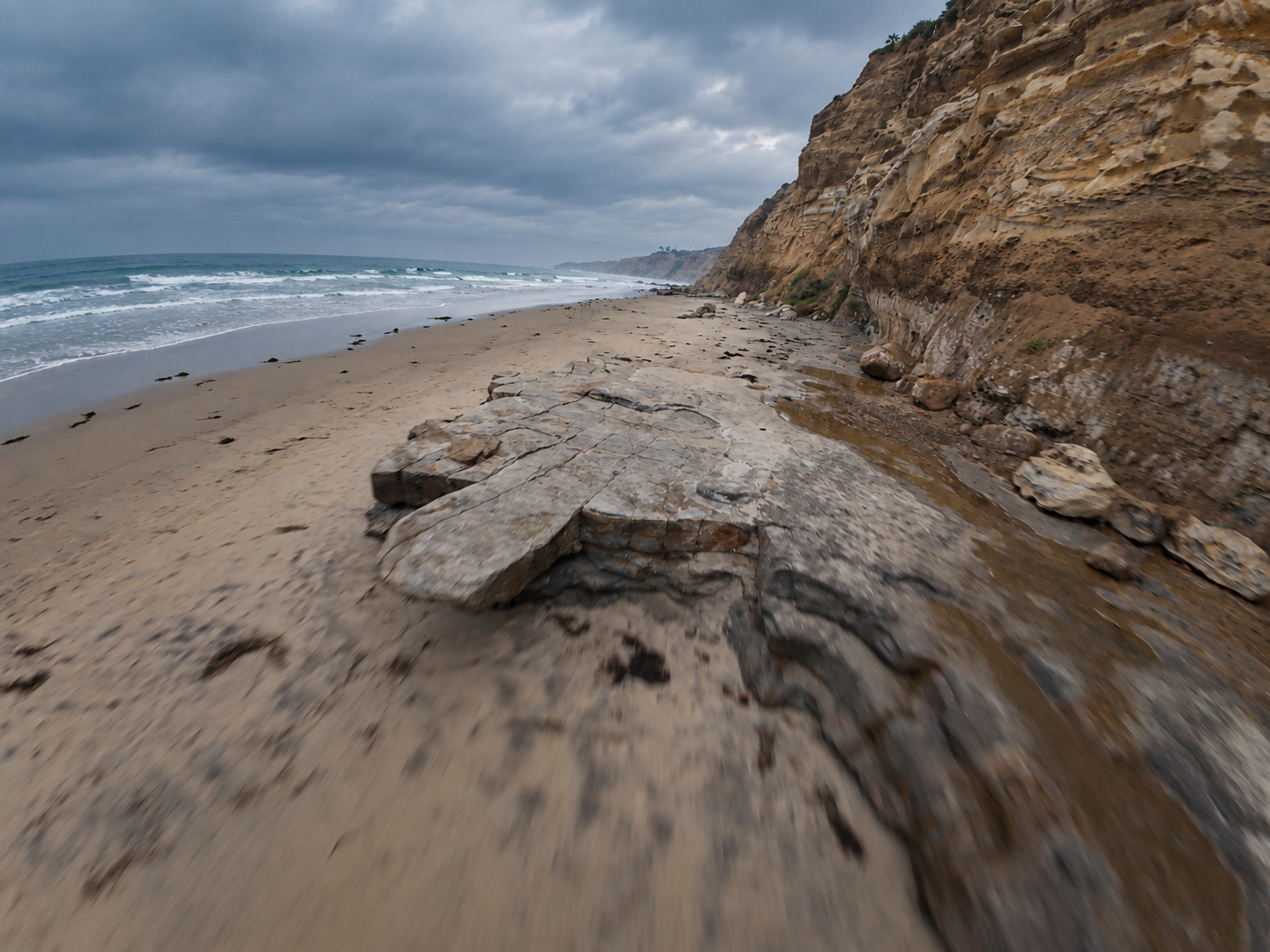 FPV flight along ocean cliffs and a rocky beach