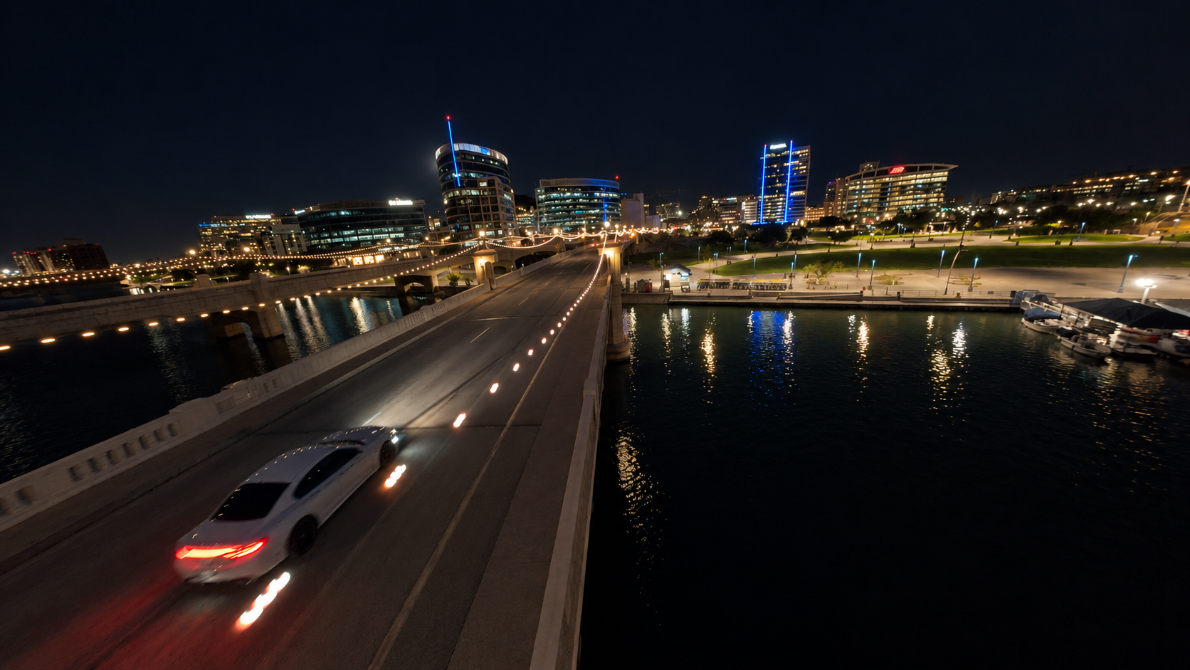Nighttime bridge and city reflected in the water